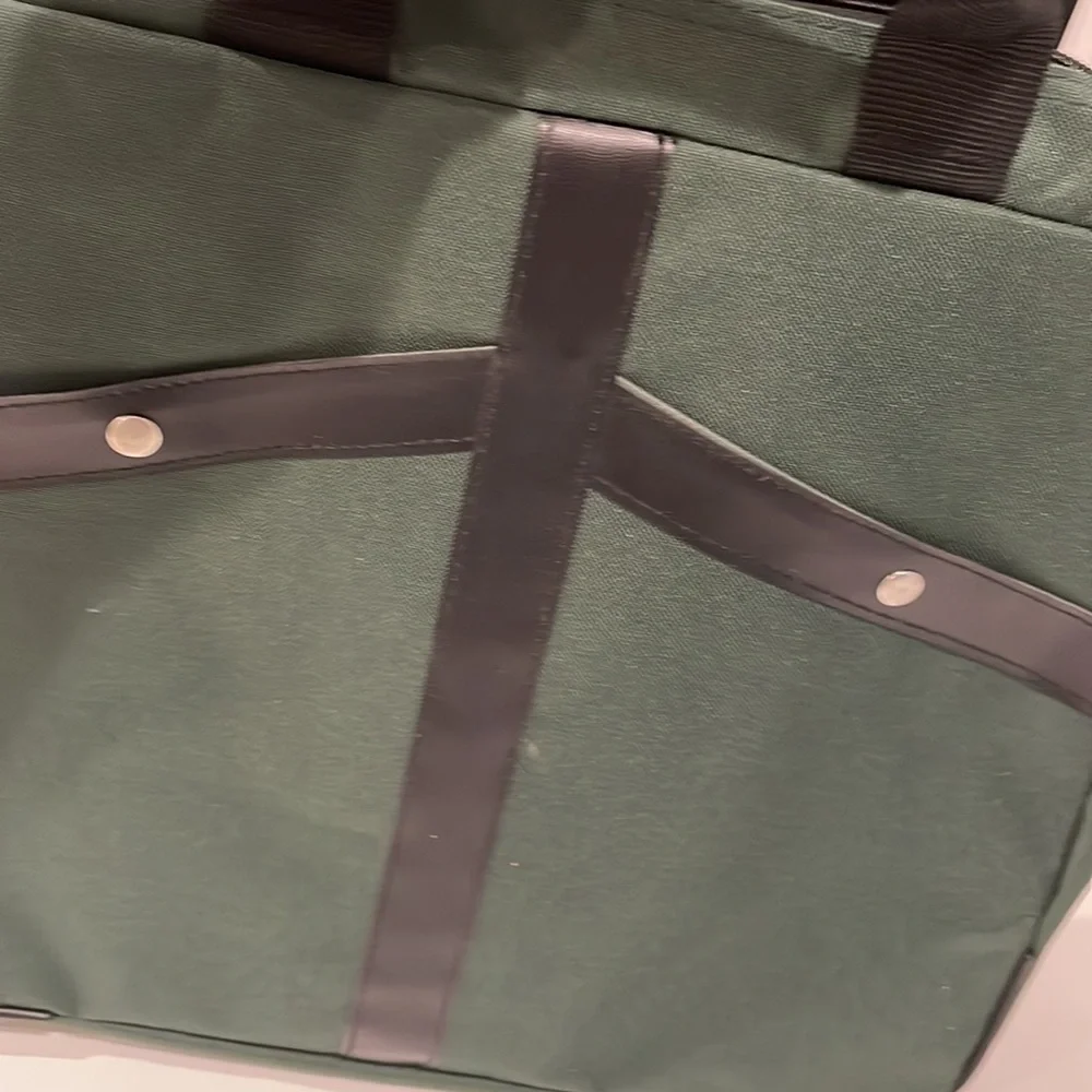 Dark green canvas briefcase with laptop sleeve and multiple pockets. NWT